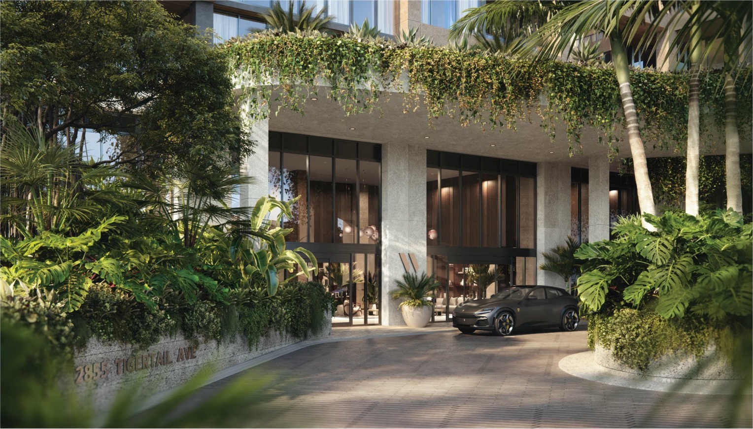 Main entrance to THE WELL Coconut Grove — coral-stone façade, valet, 24-hour security and hot-and-cold towel service on arrival.